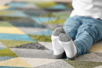 Little girl in cotton socks at home�