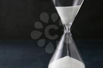 Hourglass on dark background. Time management concept�