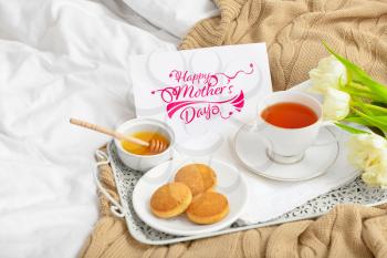 Card with text Happy Mother's day and tasty breakfast on bed�