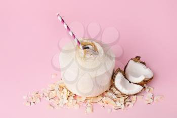 Young coconut with straw on color background�