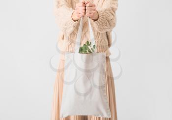Woman with eco bag on light background�