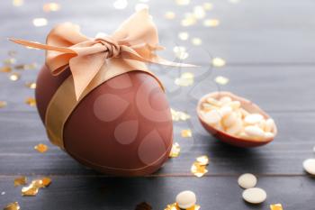Sweet chocolate Easter egg on wooden background�