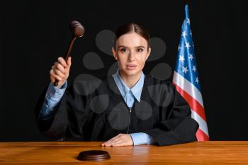 Female judge at table in courtroom�