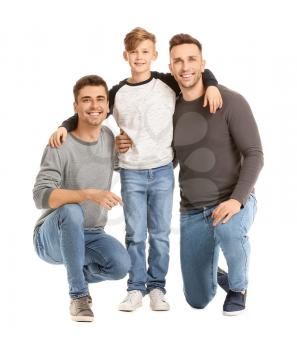 Happy gay couple with adopted child on white background�
