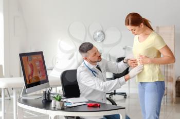 Woman visiting gastroenterologist in clinic�