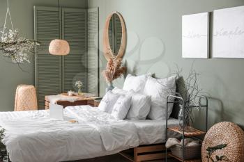 Interior of beautiful modern bedroom with spring flowers�