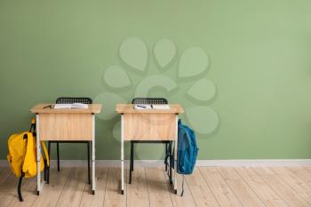 School desks near color wall in classroom�