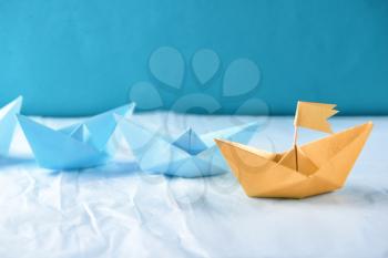 Origami boats on crumpled paper�