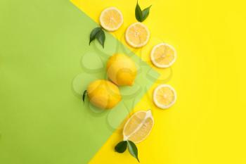 Flat lay composition with ripe juicy lemons on color background�