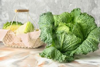 Fresh savoy cabbage on color table�