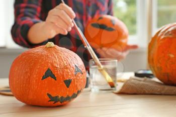 Pumpkin prepared for Halloween on wooden table�