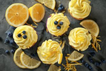 Delicious lemon cupcakes on table, top view�