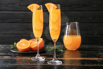 Glasses of tasty mimosa cocktail on table�