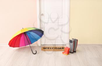 Door mat, umbrella and gumboots in hall�