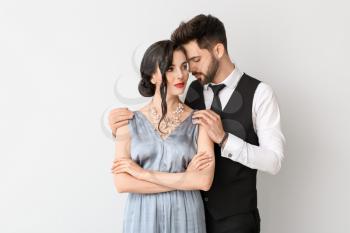 Young couple wearing stylish accessories on light background�