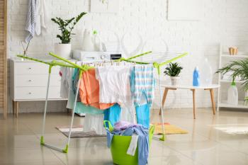 Clean clothes hanging on dryer in laundry room�