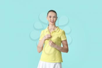 Beautiful young woman in stylish polo shirt on color background�