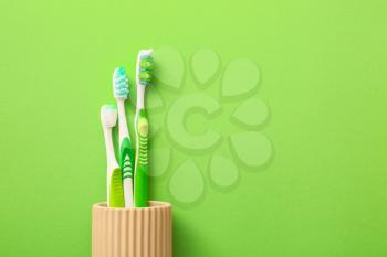Tooth brushes on color background�