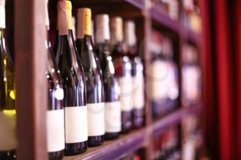 Rack with bottles of wine in store�