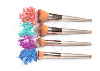 Set of makeup brushes with decorative cosmetics on white background�