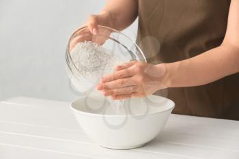 Woman preparing rice water on table�
