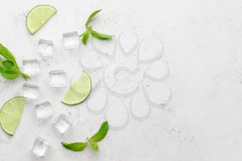 Ice cubes, mint and lime on light background�