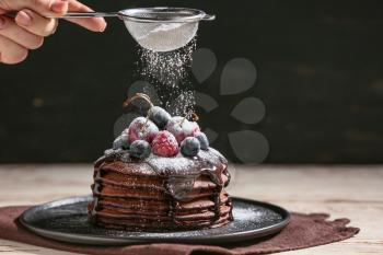 Decorating of delicious chocolate pancakes�