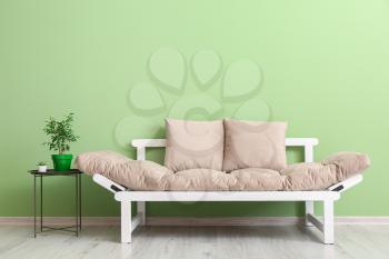 Stylish modern sofa in room�