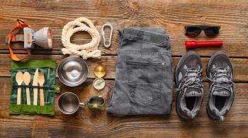 Equipment for hiking on wooden background�