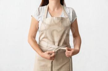 Female waiter wearing apron on white background�