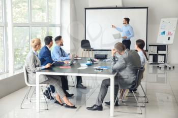 Businessman giving presentation during meeting in office�