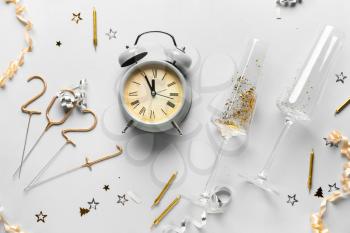 Beautiful New Year composition with alarm clock on light background�