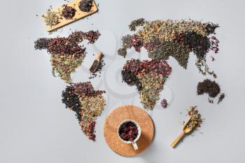 World map made of different sorts of tea and cup with dry hibiscus on light background�