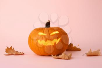 Carved Halloween pumpkin on color background�