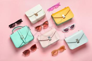 Composition with sunglasses and bags on color background�