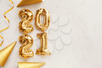 New Year composition with balloons in shape of figure 2021 on light background�