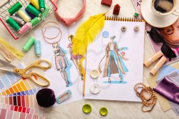Fashion designer workplace with sketches on light background�