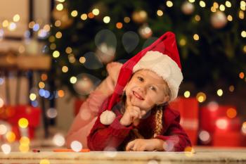 Cute little girl writing letter to Santa at home�
