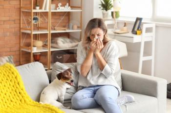 Young woman suffering from pet allergy at home�