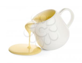 Jug with sweet condensed milk on white background�