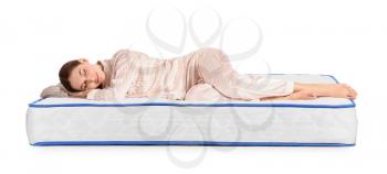 Young woman sleeping on mattress against white background�