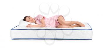 Young woman lying on mattress against white background�