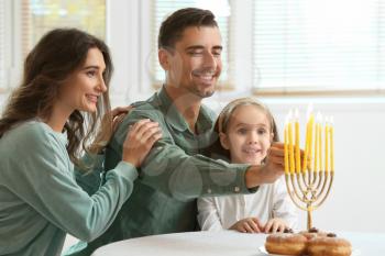 Happy family celebrating Hannukah at home�