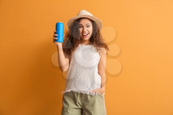 Beautiful African-American woman with soda on color background�