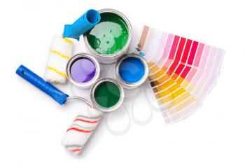 Cans of paints, rollers and palette samples on white background�