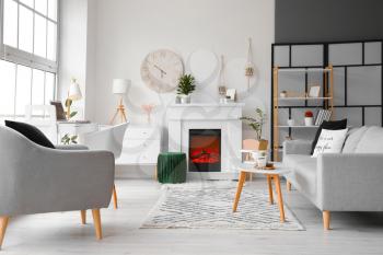 Stylish interior of modern living room with fireplace�