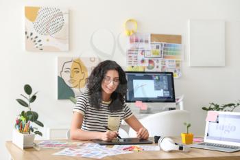 Young female designer working in office�