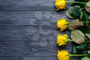 Beautiful yellow roses on wooden background�
