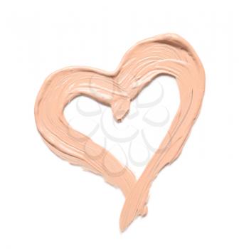 Heart made of makeup foundation on white background�