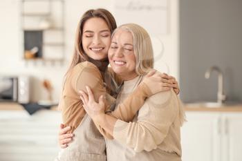 Young woman and mother spending time together at home�